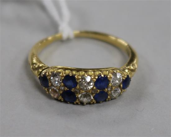 An early 20th century 18ct gold, sapphire and diamond twin row half hoop ring, size N.